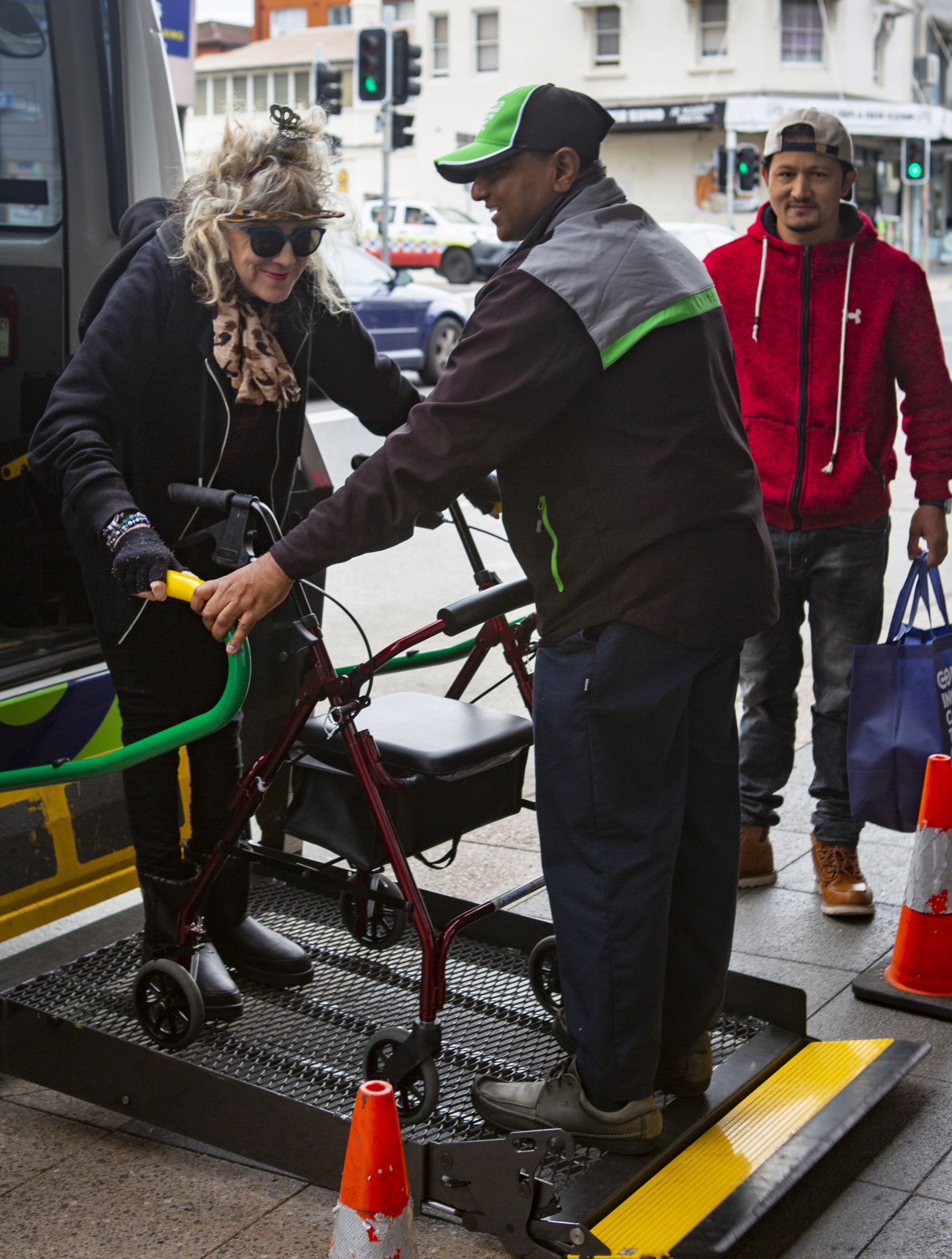 A Connect Inner West driver helping one of our customers off our wheelchair accessible transportation